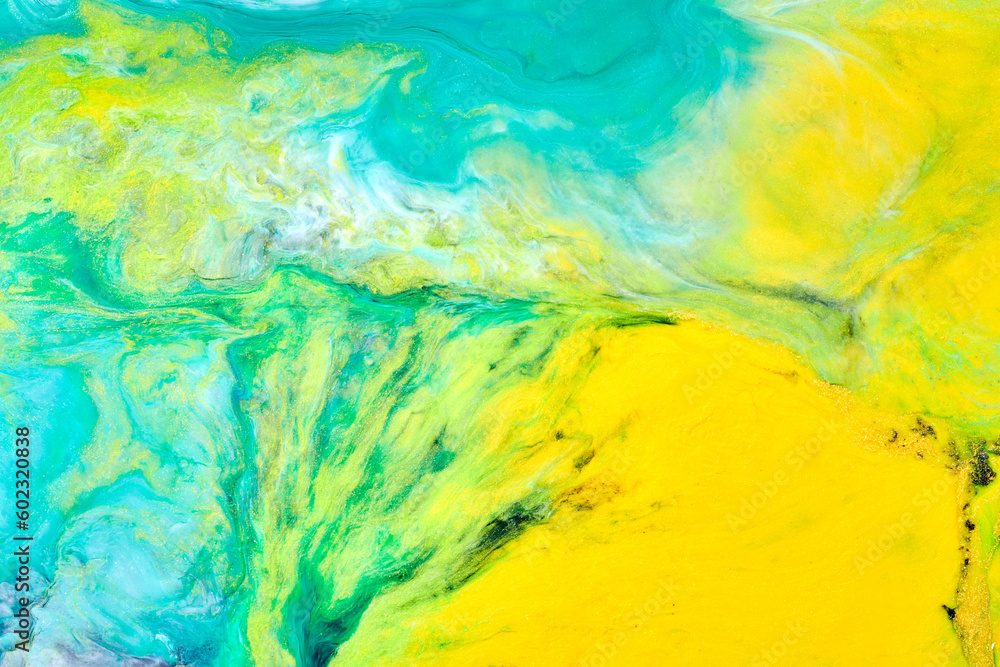Multicolored creative abstract background. Texture of acrylic paint. Stains and blots of alcohol ink green blue yellow colors, fluid art.