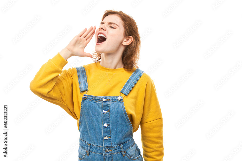 Portrait of redhead young woman screaming into her palms on white studio background. Important information, news concept Portrait of redhead young woman screaming into her palms on white studio background. Important information, news concept