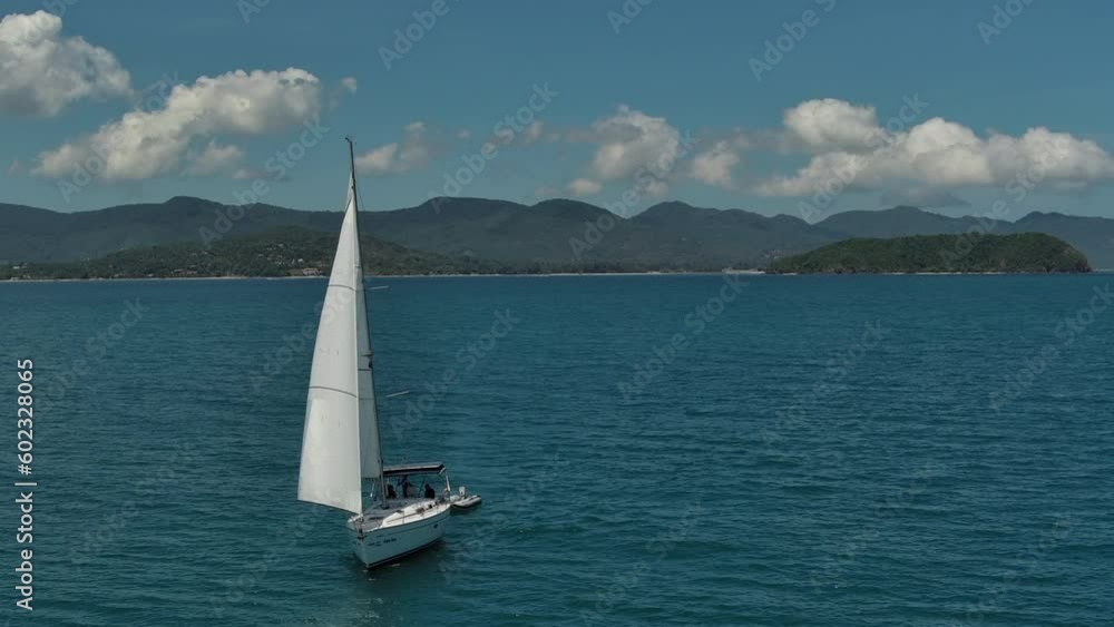 Sail boat drone film from southern Thailand - Drone flies infront of sailboat with Koh Pangan island in the background Sail boat drone film from southern Thailand - Drone flies infront of sailboat with Koh Pangan island in the background