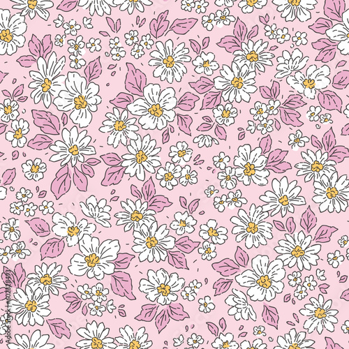 Beautiful floral pattern in small flowers. Delicate white flowers and lilac leaves. Light pink background. Liberty print. Floral seamless background. Trendy template for fashion prints. Stock pattern.
