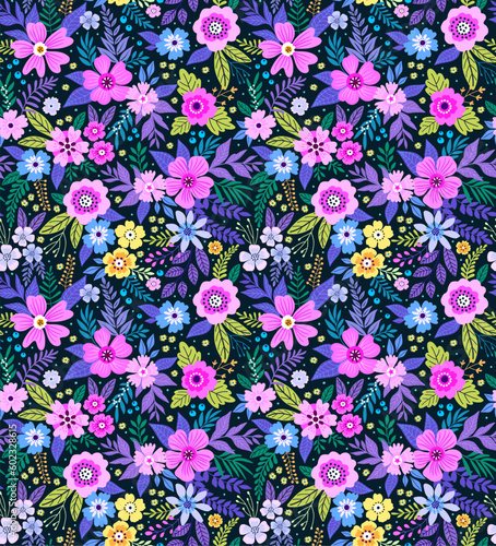 Vector seamless pattern. Cute pattern in small flowers. Small colorful flowers. Dark blue background. Trendy floral background. Bright template for fashion prints. Stock vector. © ann_and_pen