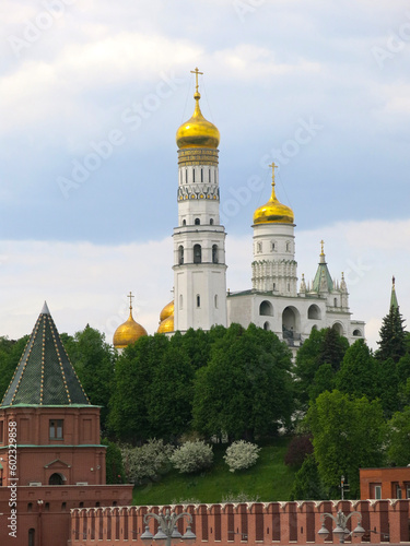 The Kremlin wall made of red brick and the Church-Bell Tower of Ivan the Great as part of the architectural ensemble of the Cathedral Square of the Moscow Kremlin