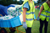 Recycling, community service hands and volunteer work outdoor with cans and garbage at a park. Cleaning, sustainability and bottle recycle with people with rubbish and pollution for environment