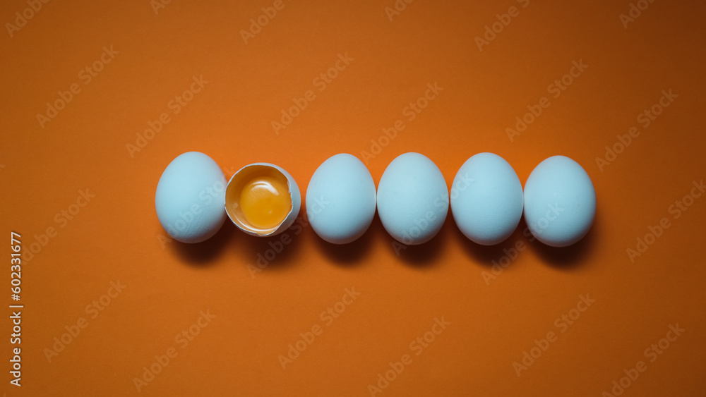 Row White eggs and egg yolk on the yellow background. Row White eggs and egg yolk on the yellow background.