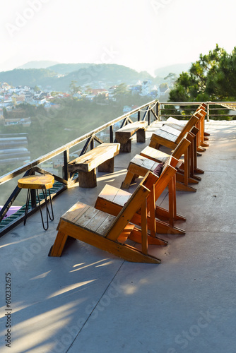 Wooden chairs without people against sunset in mountains of Da Lat in Vietnam © Tatiana