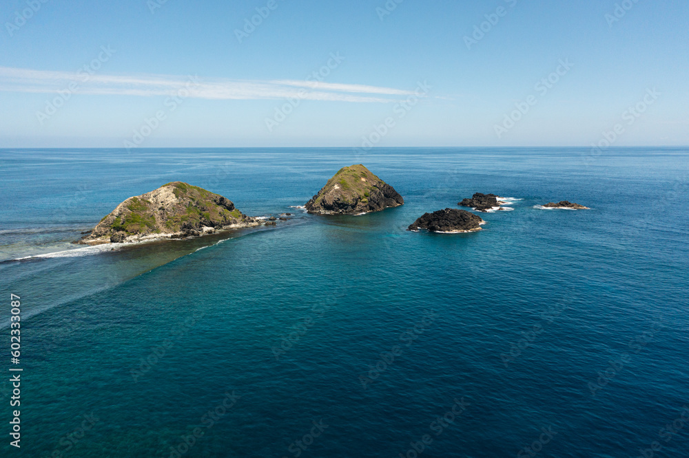 Aerial view of rocky islands and blue ocean. Seascape in the Philippines.