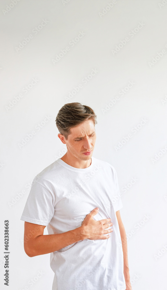 Stomachache problems. Food poisoning. Sick displeased unhealthy man touching his painful belly isolated on white empty space background. Stomachache problems. Food poisoning. Sick displeased unhealthy man touching his painful belly isolated on white empty space background.