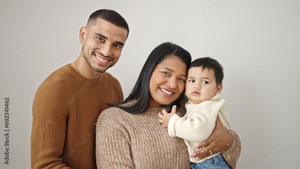 Couple and son hugging each other standing over isolated white background