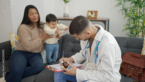 Couple and son prescribing medication at clinic © Krakenimages.com