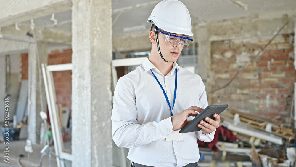 Young hispanic man architect standing with relaxed expression using touchpad at construction site Young hispanic man architect standing with relaxed expression using touchpad at construction site