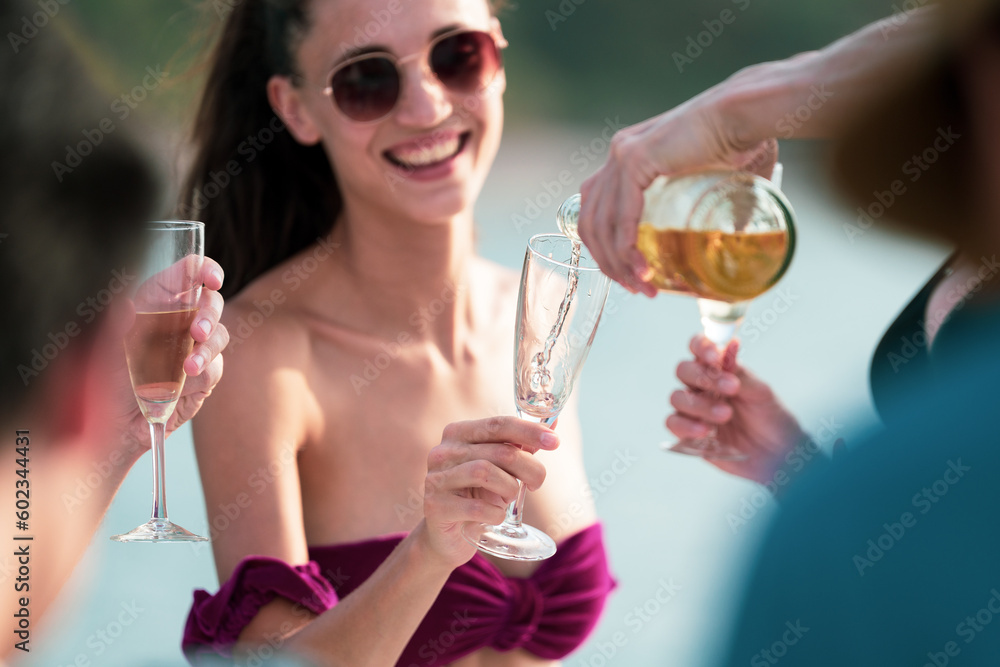 Man and woman friends group enjoy celebration party and fun luxury summer outdoor lifestyle by drinking champagne together, travel vacation on catamaran yacht boat sailing in tropical sea sunset on Man and woman friends group enjoy celebration party and fun luxury summer outdoor lifestyle by drinking champagne together, travel vacation on catamaran yacht boat sailing in tropical sea sunset on