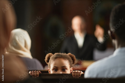 Print op canvas Portrait of African American little girl looking at camera while sitting on benc