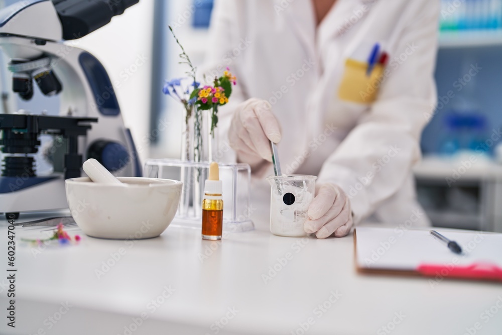 Middle age woman scientist working at laboratory Middle age woman scientist working at laboratory