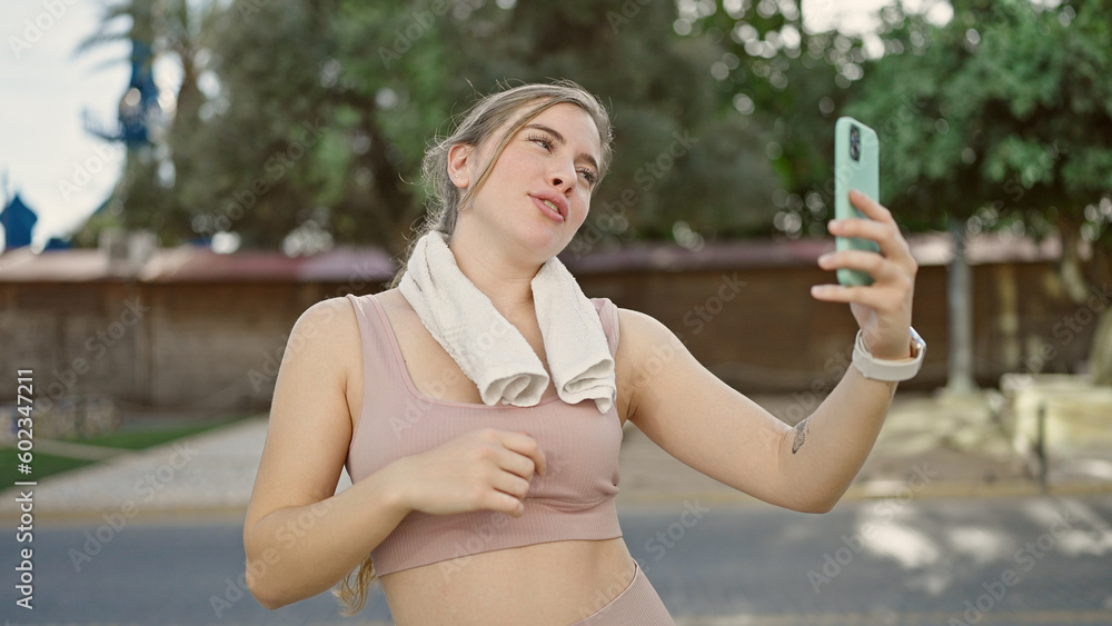 Young blonde woman wearing sportswear having video call at street Young blonde woman wearing sportswear having video call at street