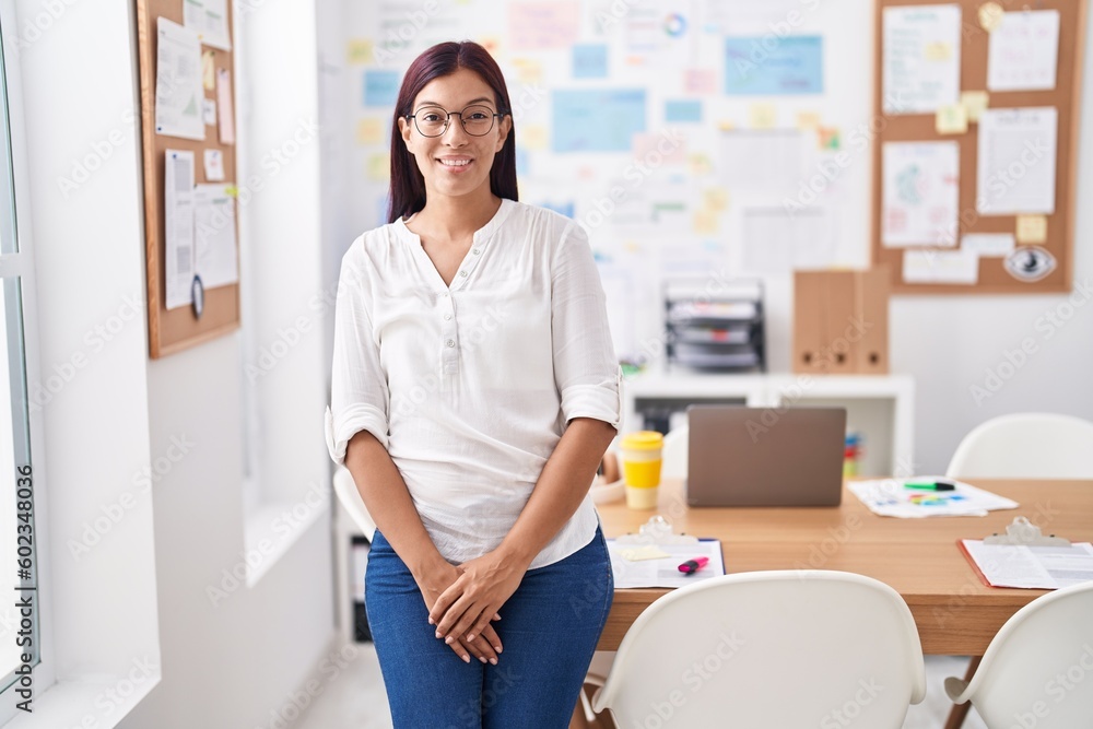 Young beautiful hispanic woman business worker smiling confident standing at office Young beautiful hispanic woman business worker smiling confident standing at office