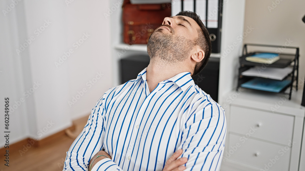 Young hispanic man business worker sleeping at office