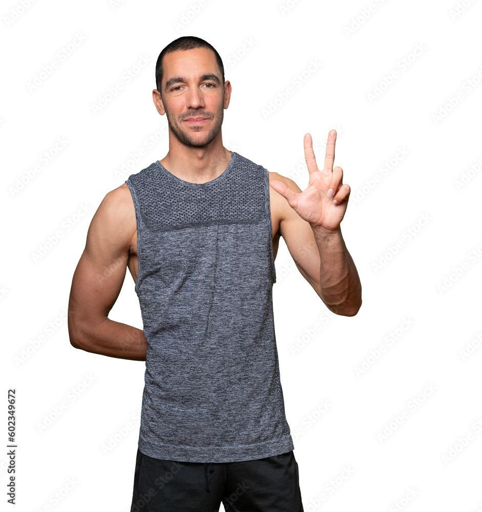 Naklejka premium Young man making a number three gesture