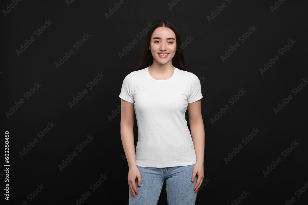 Woman wearing white t-shirt on black background Woman wearing white t-shirt on black background