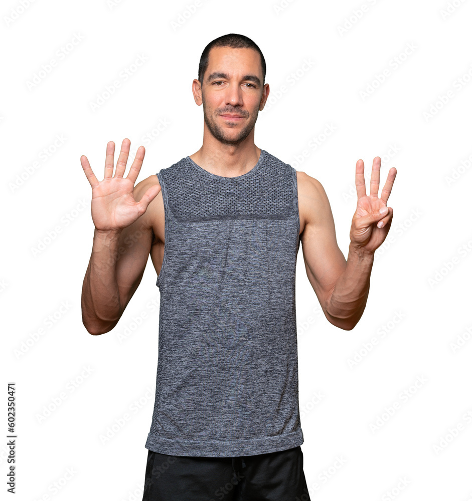 Happy young man doing a number eight gesture with his hands Happy young man doing a number eight gesture with his hands