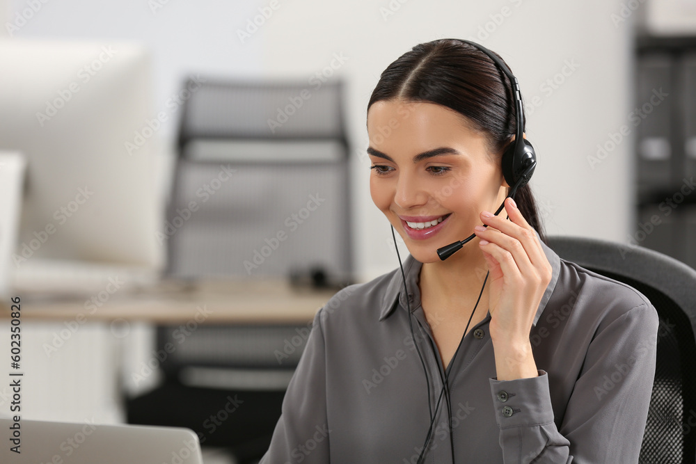 Hotline operator with headset working in office Hotline operator with headset working in office