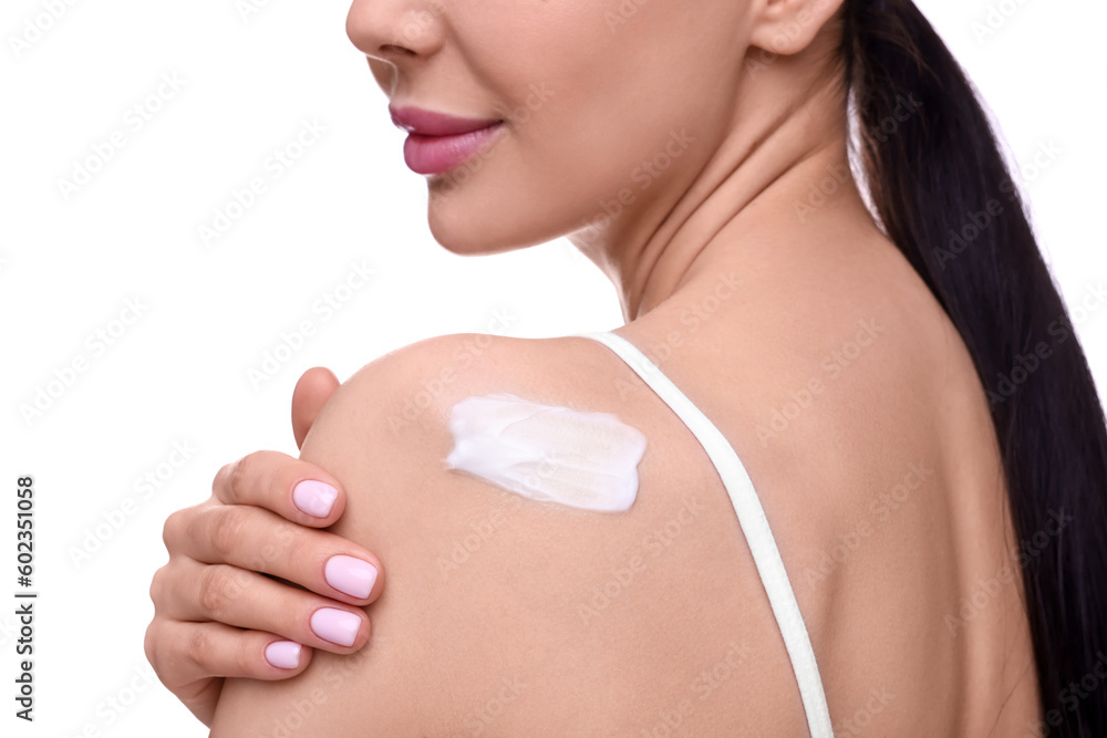 Woman with smear of body cream on her shoulder against white background, closeup