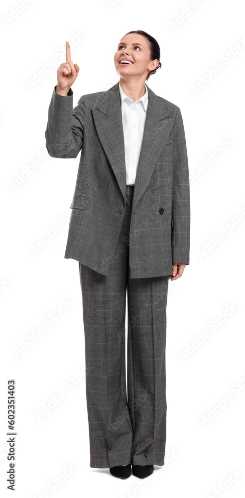 Beautiful businesswoman in suit pointing at something on white background Beautiful businesswoman in suit pointing at something on white background