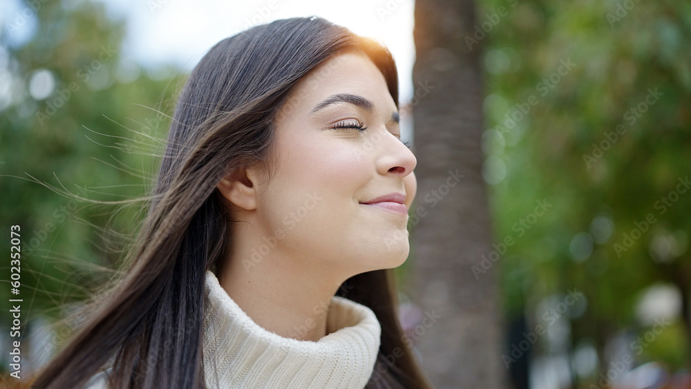 Young beautiful hispanic woman breathing with closed eyes at park Young beautiful hispanic woman breathing with closed eyes at park