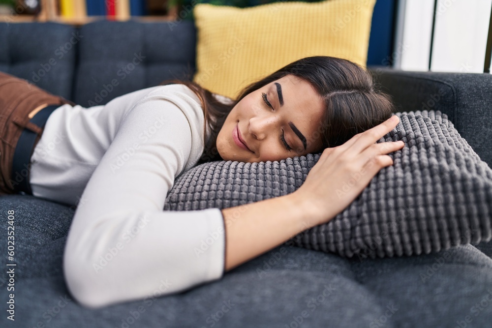 Young beautiful hispanic woman lying on sofa sleeping at home Young beautiful hispanic woman lying on sofa sleeping at home