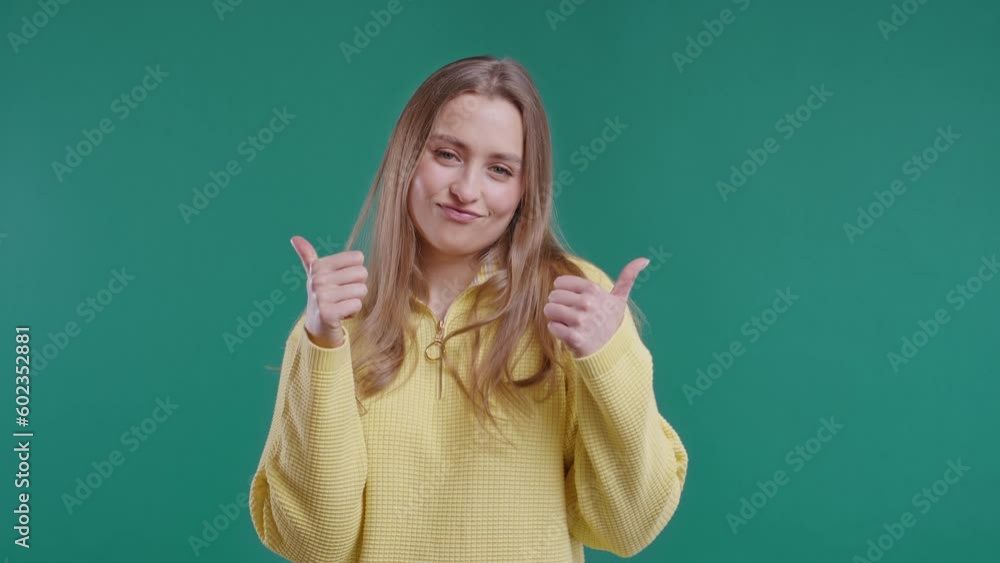 Happy woman with hand sign like, thumbs up gesture. Lady on green background Happy woman with hand sign like, thumbs up gesture. Lady on green background