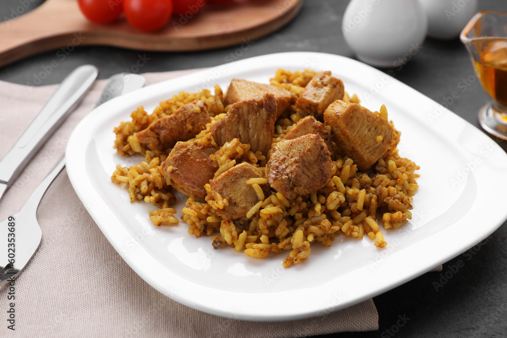 Delicious rice with chicken served on table, closeup Delicious rice with chicken served on table, closeup