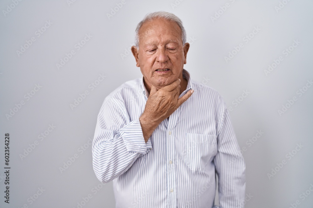 Senior man with grey hair standing over isolated background touching painful neck, sore throat for flu, clod and infection