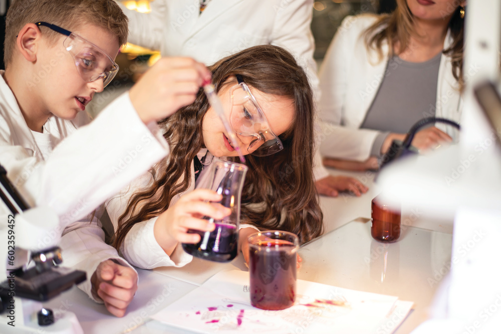 Elementary school children doing experiments in the laboratory Elementary school children doing experiments in the laboratory