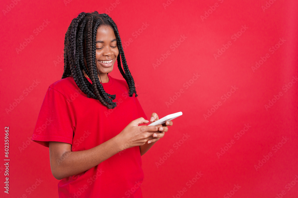 Happy african woman smiling while using the mobile Happy african woman smiling while using the mobile