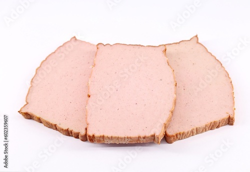 Slices of Leberkase on white background. It is a german speciality consisting of beef, pork and bacon and is made by grinding this ingredients and then baking.  photo
