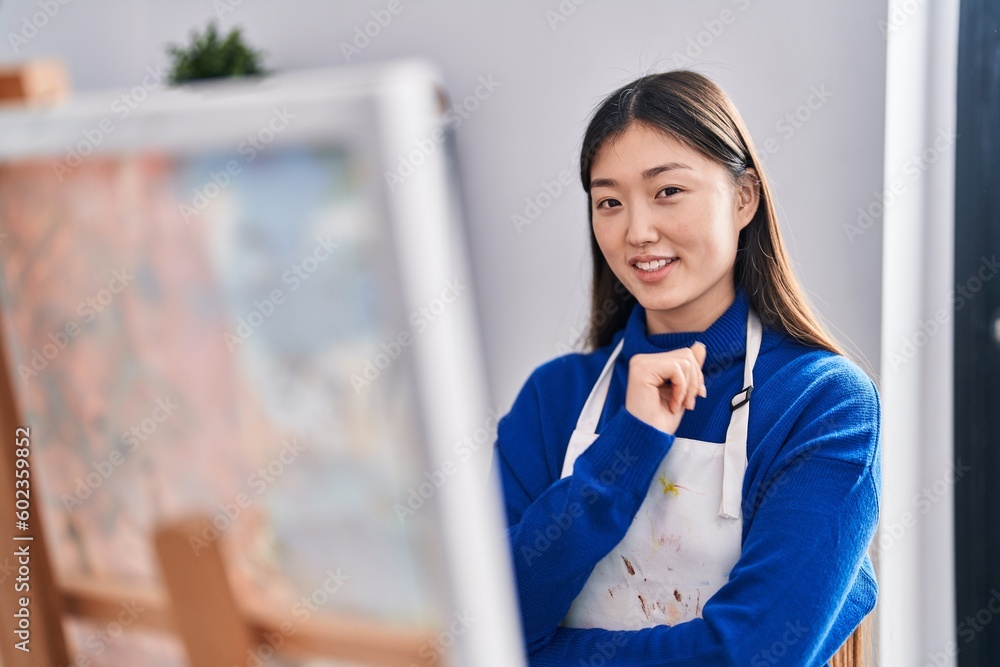 Chinese woman artist smiling confident looking draw at art studio Chinese woman artist smiling confident looking draw at art studio