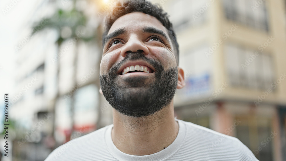 Young hispanic man smiling confident looking to the sky at street Young hispanic man smiling confident looking to the sky at street