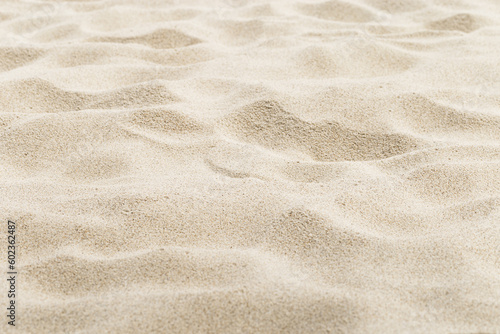 Fine Sand texture natural surface. Close up of sand on shore sea, white waves dunes, beige neutral color, minimal nature aesthetics wallpaper. Sandy beach for background, selective focus