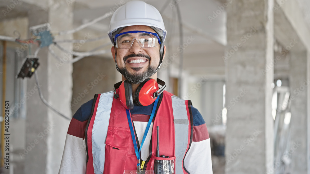 Young latin man builder smiling confident standing at construction site Young latin man builder smiling confident standing at construction site