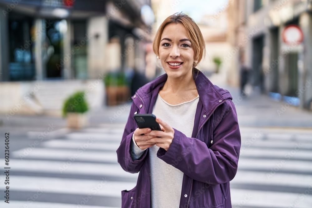 Young woman smiling confident using smartphone at street Young woman smiling confident using smartphone at street