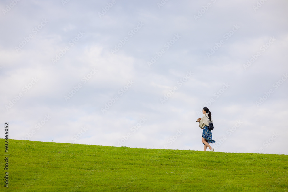 Woman with her dachshund dog walking in the park Woman with her dachshund dog walking in the park