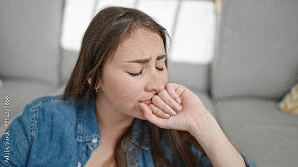 Young beautiful hispanic woman sitting on floor with sad expression at home Young beautiful hispanic woman sitting on floor with sad expression at home
