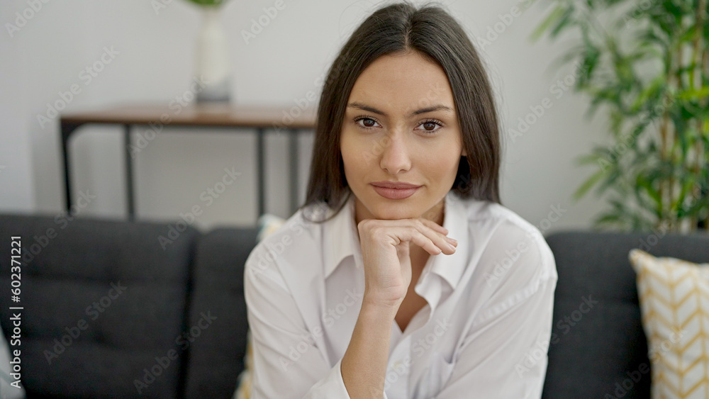 Young beautiful hispanic woman smiling confident sitting on sofa at home Young beautiful hispanic woman smiling confident sitting on sofa at home