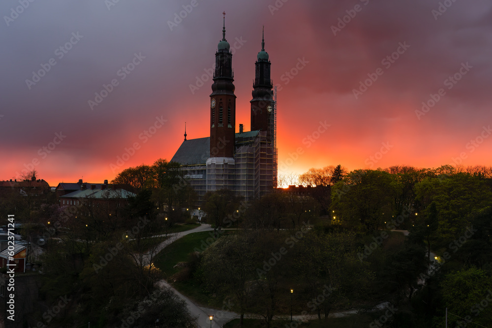 Fototapeta premium Beautiful panoramic night view of the famous Hogalid church on city park hill with dramatic sunset sky in Stockholm.