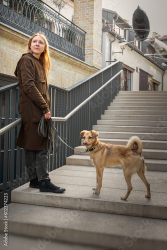 Obraz na płótnie Beautiful blonde girl with dog in the city w salonie