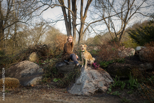 Obraz na płótnie Beautiful blonde girl with dog walking in the park w salonie