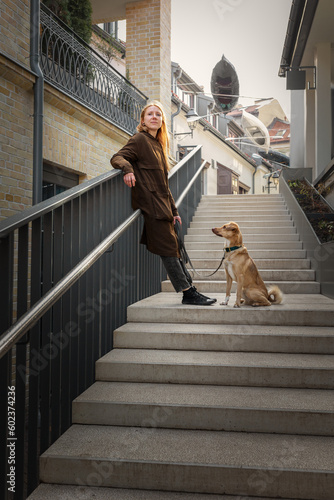 Obraz na płótnie Beautiful blonde girl with dog in the city w salonie