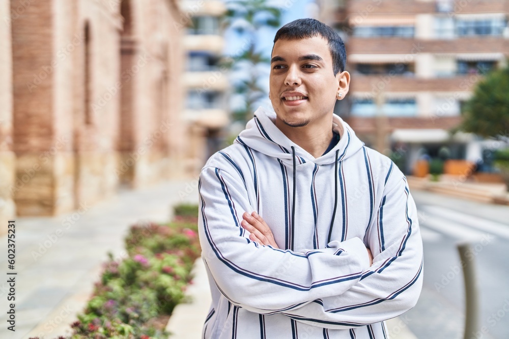 Young man smiling confident standing with arms crossed gesture at street Young man smiling confident standing with arms crossed gesture at street