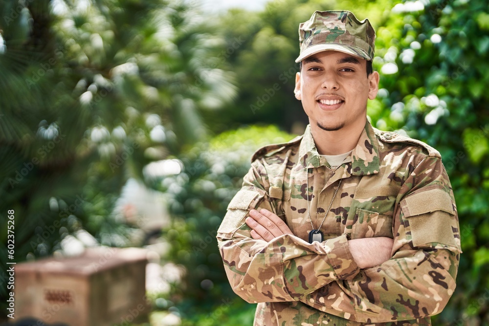 Young man army soldier standing with arms crossed gesture at park