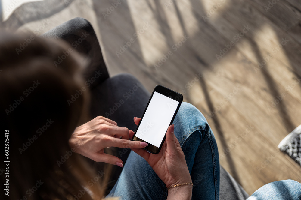 woman holding a smartphone with a blank screen, representing the concept of technology and a smart home. It's perfect for tech-related companies, web design, and marketing projects. woman holding a smartphone with a blank screen, representing the concept of technology and a smart home. It's perfect for tech-related companies, web design, and marketing projects.