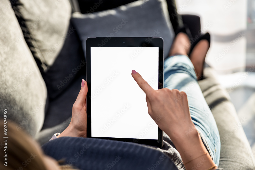 woman holding a tablet with a blank screen, representing the concept of technology and a smart home. It's perfect for tech-related companies, web design, and marketing projects.

